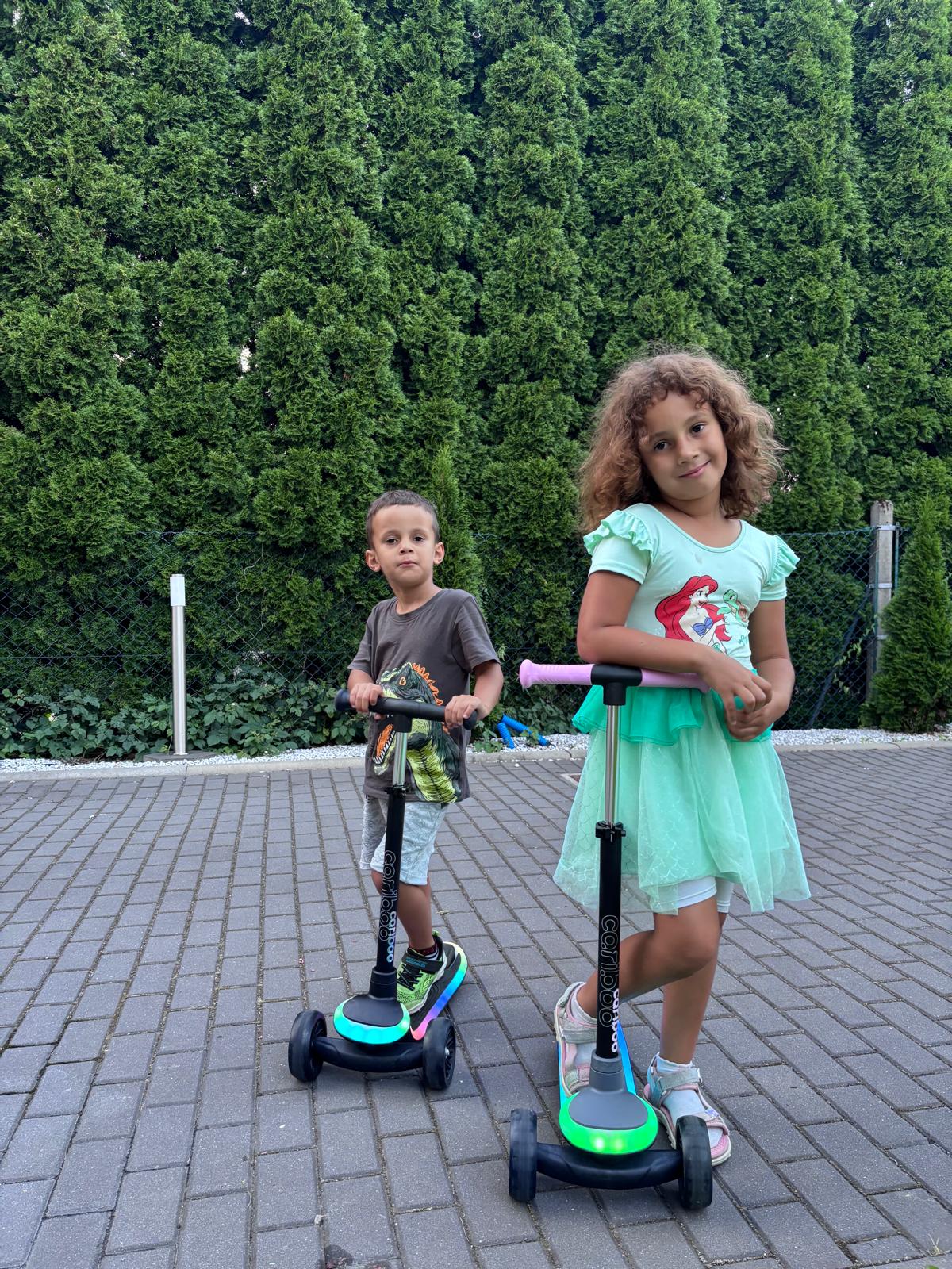Girl posing with her scooter, original photo